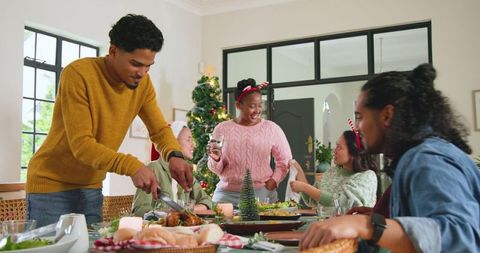 Diverse Friends Enjoy Holiday Feast Around Festive Table