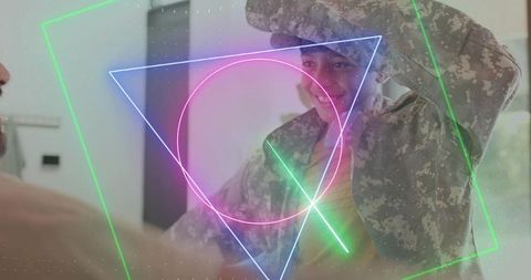 Military dad saluting during homecoming with child in camo jacket and neon overlay