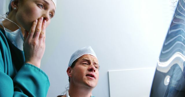 Doctors Analyzing X-Ray with Concerned Faces in Hospital - Download Free Stock Images Pikwizard.com