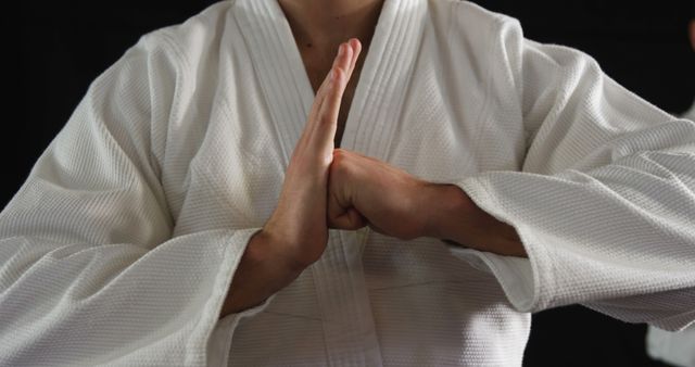 Martial Arts Practitioner in White Gi Performing Hand Salutation - Download Free Stock Images Pikwizard.com