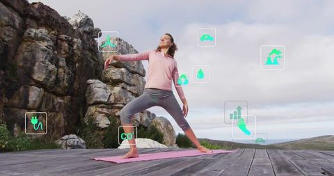 Woman practicing yoga on cliffside deck with eco technology icons and ocean horizon view