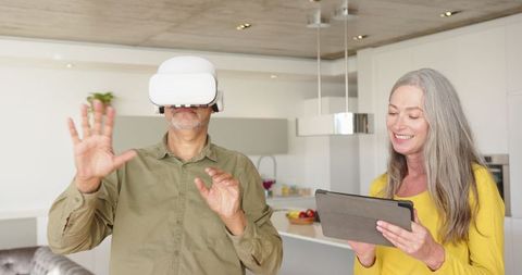 Senior couple engaging with vr headset and tablet technology