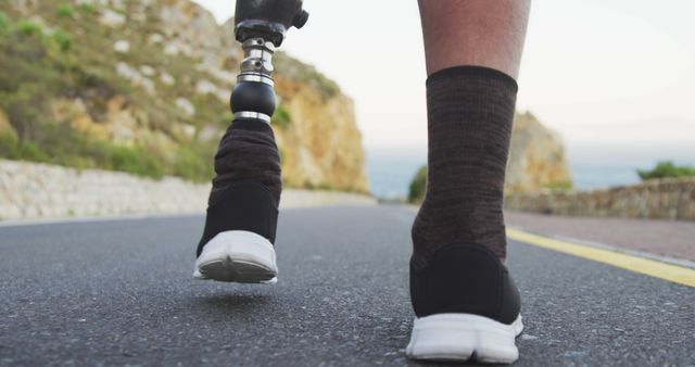 Close-up of amputee wearing prosthetic leg and running shoes on road - Download Free Stock Images Pikwizard.com