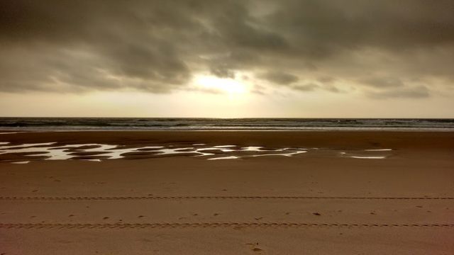 Dramatic Seascape with Overcast Sky and Reflections - Download Free Stock Photos Pikwizard.com