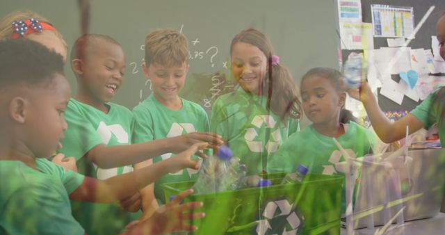 Image of a group of schoolchildren recycling plastic bottles and putting them into a green box with recycling sign and grass moving in the foreground 4k