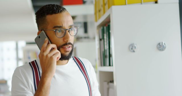 Young Professional Man Talking on Smartphone in Modern Office - Download Free Stock Images Pikwizard.com