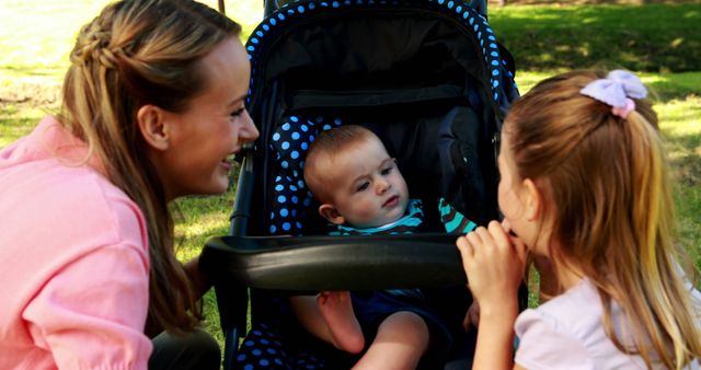 Happy Family in Park with Baby in Stroller and Sister Smiling - Download Free Stock Images Pikwizard.com