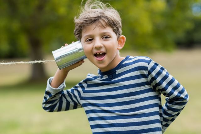 Boy listening through tin can phone - Download Free Stock Photos Pikwizard.com