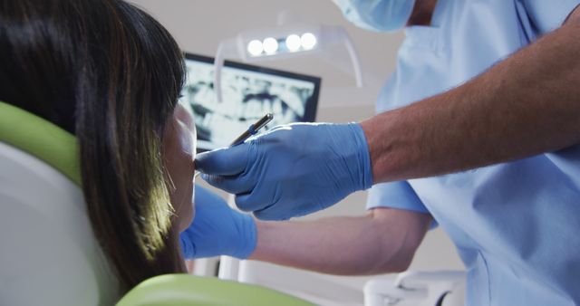 Dentist Treating Patient with Gloved Hands and Dental Equipment - Download Free Stock Images Pikwizard.com