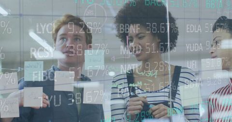 Diverse Colleagues Collaborating with Financial Data in Modern Office