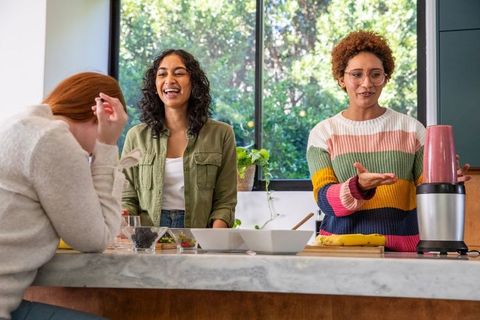 Diverse Female Friends Enjoying Smoothie Preparation