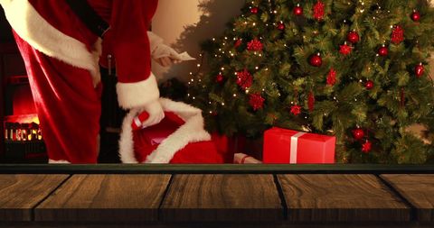 Santa Delivering Gifts by the Christmas Tree Festive Scene