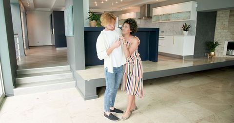 Happy Couple Dancing in New Modern Home Interior