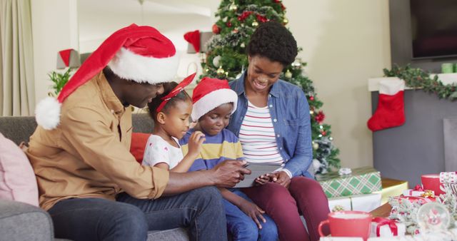 Happy african american family having tablet image call. Spending quality time with family at christmas concept.