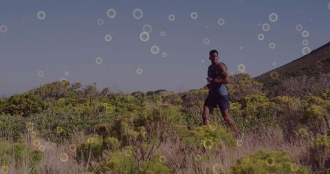 Athletic Man Running on Sunny Hill Trail for Motivation and Fitness