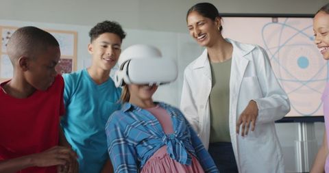 Students exploring virtual reality with teacher guidance in classroom