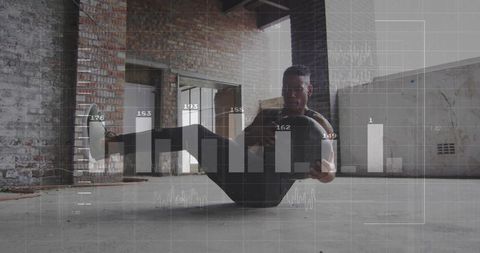 Man Exercising with Medicine Ball Displays Innovative Vitality in Industrial Space