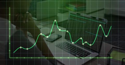Professional Analyzing Data on Laptop with Graph Overlay