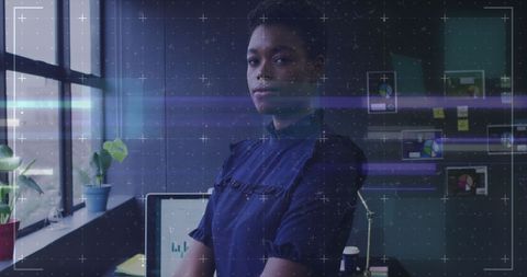 Confident Businesswoman in Tech-Centric Workspace