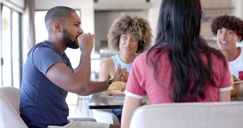 Diverse friends joyfully dining together and engaged in lively discussion