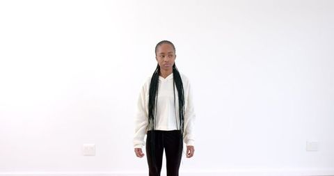 Confident Young Woman in Casual Wear Against White Background