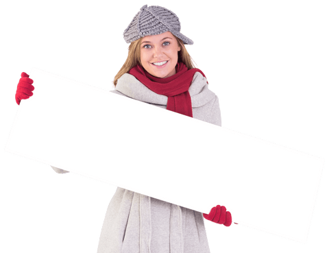 Smiling woman in winter outfit holding transparent sign