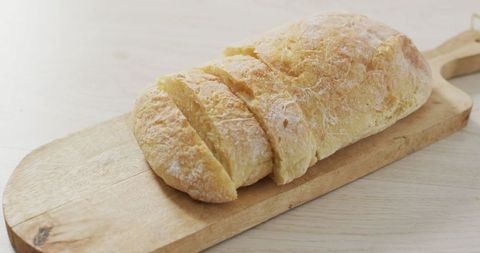 Fresh homemade artisan bread on rustic wooden board