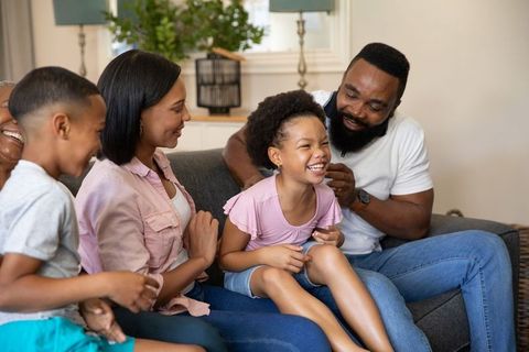 Radiant Family Bonding with Laughter and Warmth in Living Room