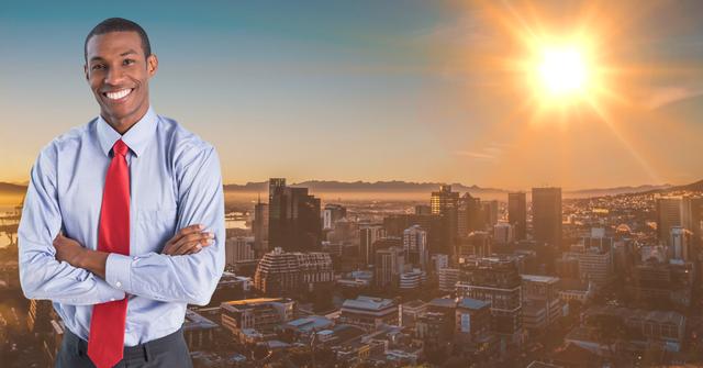 This image of a confident businessman standing with arms crossed against a cityscape at sunrise is ideal for use in corporate presentations, business websites, and promotional materials. It conveys themes of success, leadership, and professionalism, making it suitable for illustrating concepts related to career growth, urban development, and business opportunities.