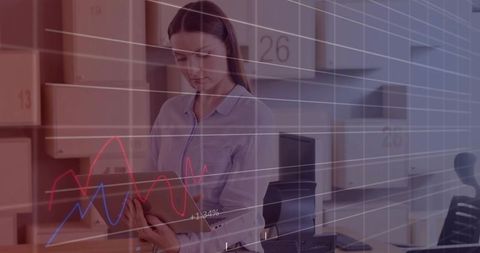 Warehouse manager analyzing tablet with inventory analytics and logistics dashboard