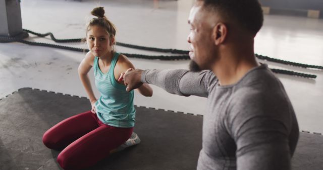 Two fitness partners are seen motivating each other during a workout session in a modern gym. They show camaraderie and encouragement. Ideal for use in articles about fitness, teamwork, motivation, or gym activities. Suitable for fitness blogs, motivational content, or gym advertisements.