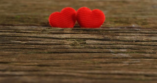 Two red hearts tuck on the wooden plank - Download Free Stock Photos Pikwizard.com