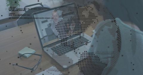 Man leaning over laptop with globe data overlay, remote work, glasses on desk