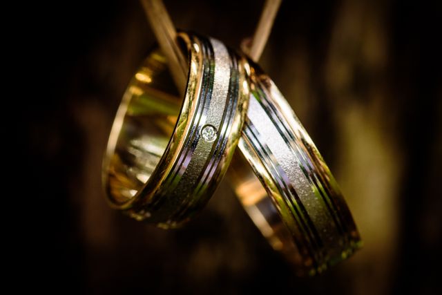 Golden Wedding Rings with Diamond on Wooden Background - Download Free Stock Photos Pikwizard.com