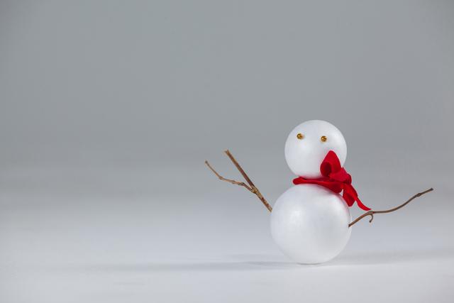 This minimalist Christmas snowman ornament with a red scarf is perfect for holiday-themed projects. Use it for greeting cards, festive advertisements, or winter decoration ideas. Its simple and clean design makes it versatile for various creative uses.