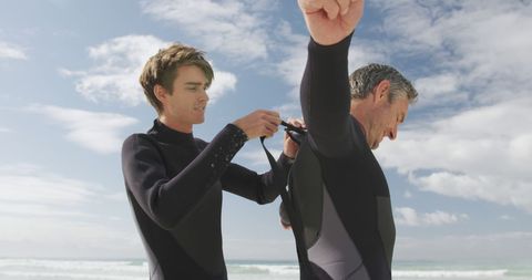 Father and Son Bonding While Preparing to Surf