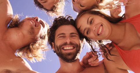 Diverse Group Enjoying Outdoor Friendship Circle Under Blue Sky