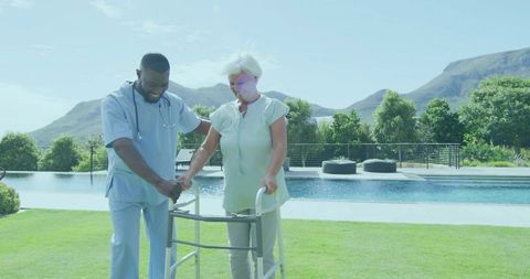 Caregiver Assisting Senior Patient with Walker in Serene Outdoor Setting