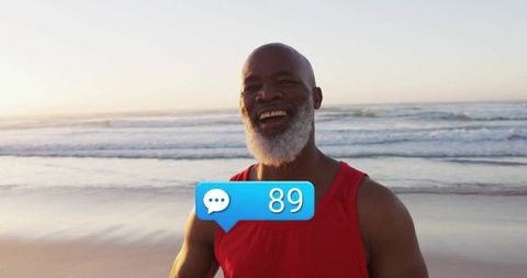 Happy senior man on beach with social engagement icon