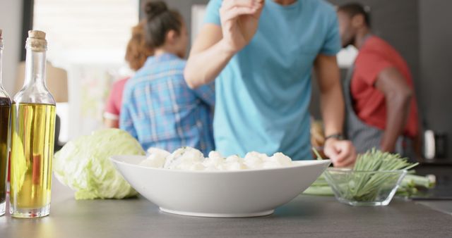 Friends Cooking Together Preparing Vegetable Dish in Modern Kitchen - Download Free Stock Images Pikwizard.com