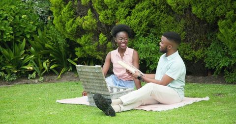 Joyful Couple Enjoying Picnic Together in Sunny Park
