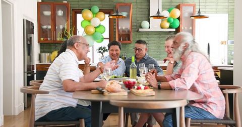 Happy Seniors Enjoying Meals and Conversation at a Celebration