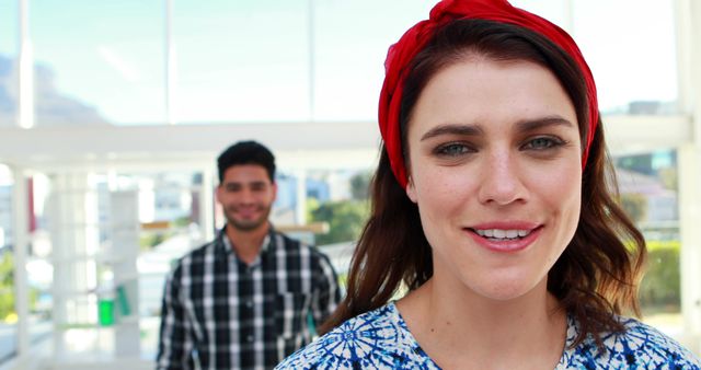 Close-up of Smiling Woman with Man in Background in Bright Room - Download Free Stock Images Pikwizard.com