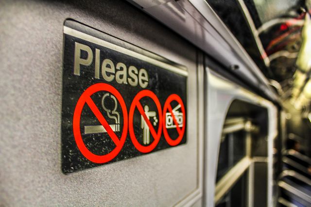 Clear display of rules and prohibitions inside public transport. Useful for illustrating urban transportation etiquette, safety regulations, public decorum, and transportation systems. Ideal for articles on commuting, public transport policies, and urban lifestyle.