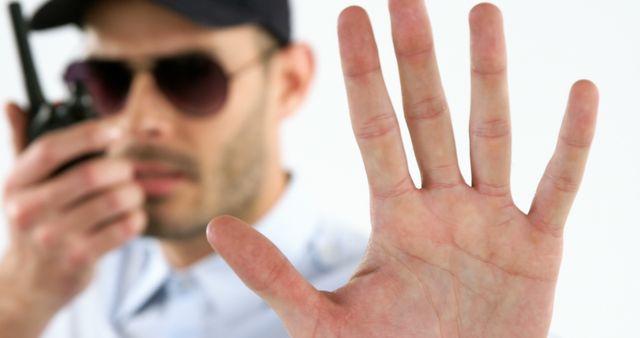 A man gestures to stop, hinting at privacy needs, while holding a camera. - Download Free Stock Photos Pikwizard.com