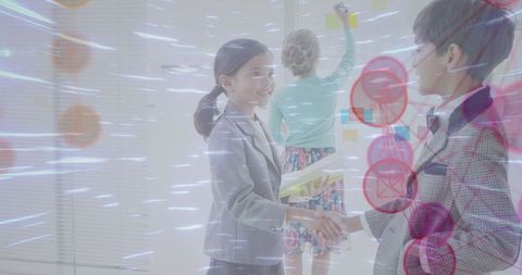 Young entrepreneurs shaking hands in futuristic office