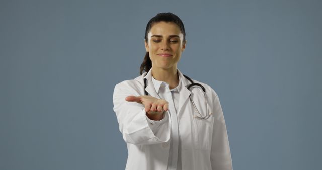 Smiling Female Doctor Gesturing with Open Hand - Download Free Stock Images Pikwizard.com