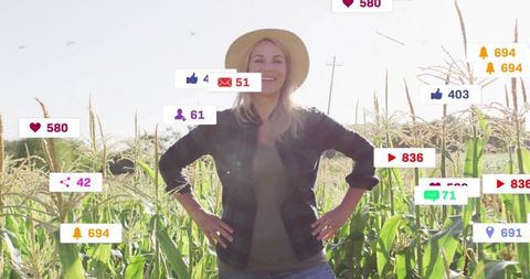 Smiling Woman Influencer Posing in Sunlit Cornfield with Social Media Engagement Icons