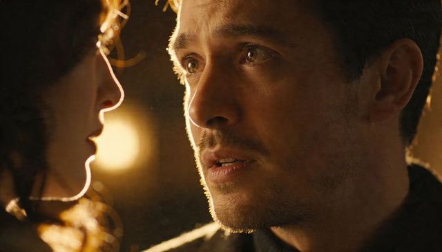 Couple sharing intimate moment with warm rimlight and cinematic closeup portrait