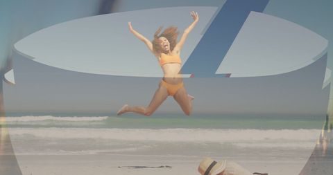 Joyful young woman jumping on sunny beach in orange bikini